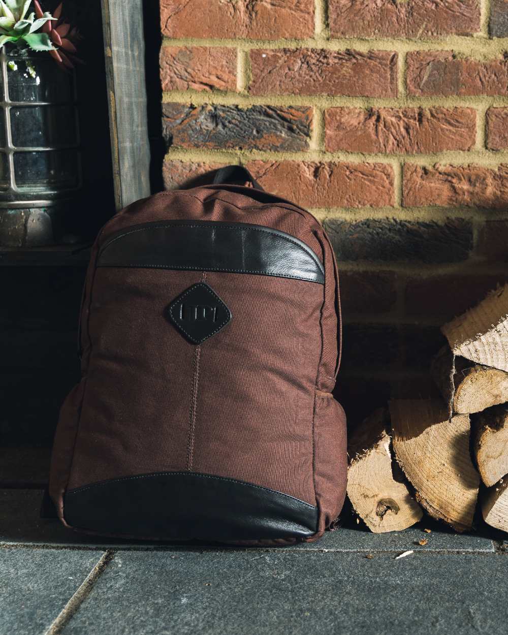 Brown coloured Jack Pyke Canvas Field Pack on brick wall background #colour_brown