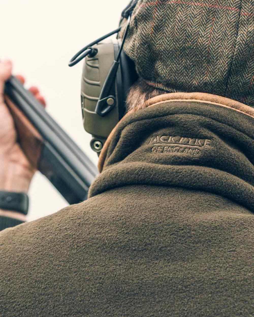 Dark Olive coloured Jack Pyke Countryman Fleece Gilet on sky background #colour_dark-olive
