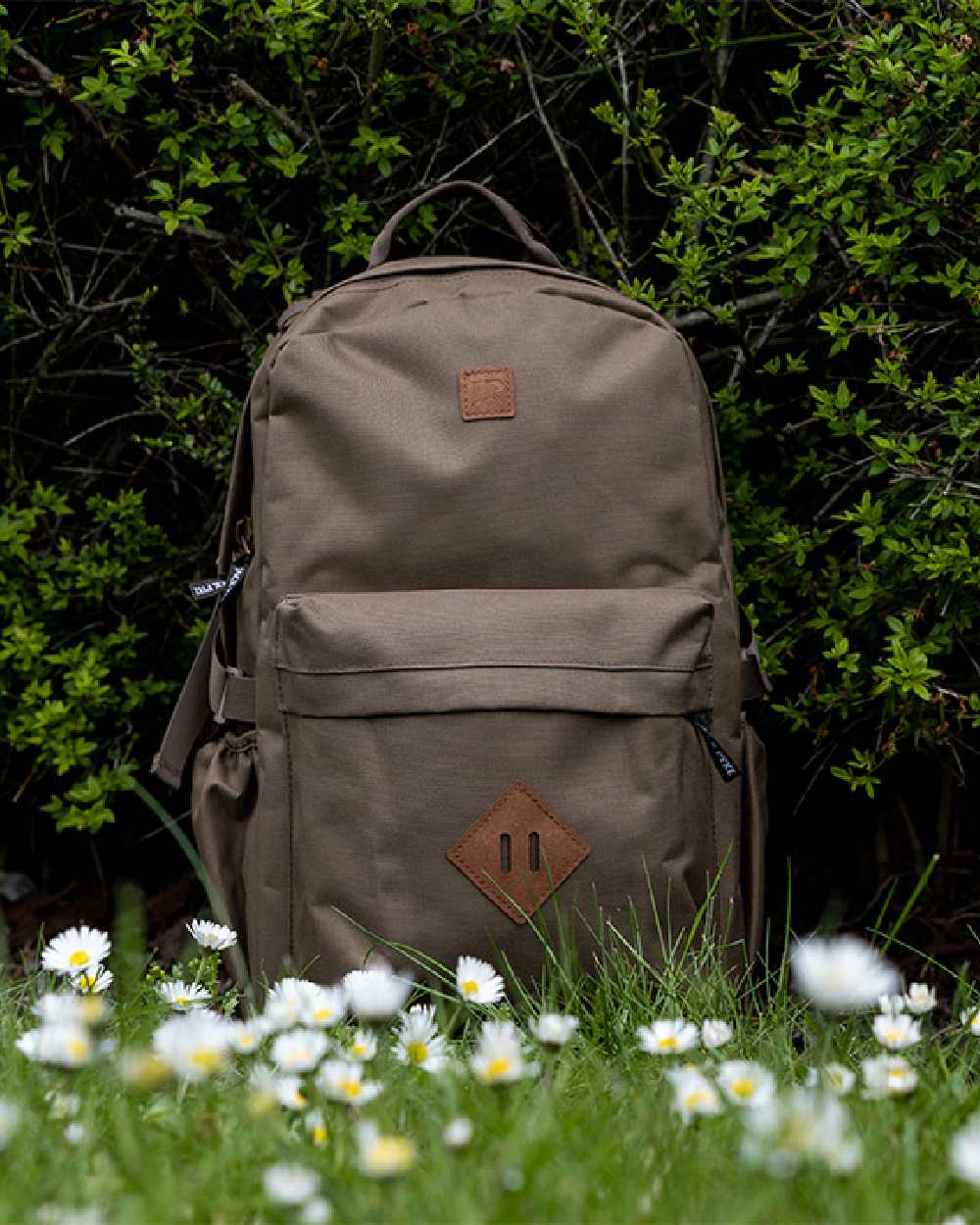Olive Brown coloured Jack Pyke Harrier Rucksack on garden background #colour_olive-brown