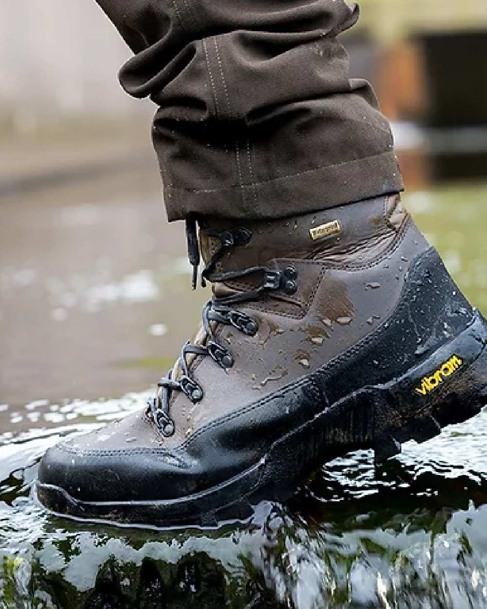 Brown coloured Jack Pyke Hunters Boots on water background #colour_brown
