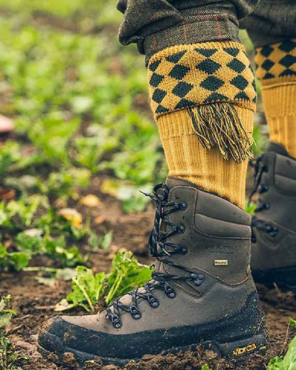 Brown coloured Jack Pyke Hunters Boots on soil background #colour_brown