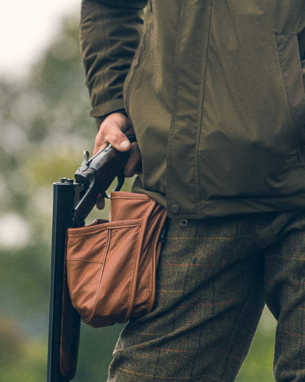 Tan coloured Jack Pyke Leather Cartridge Pouch on blurry background #colour_tan