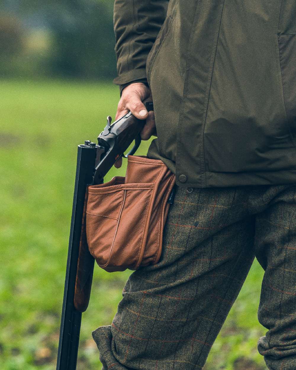 Tan coloured Jack Pyke Leather Cartridge Pouch on blurry background #colour_tan