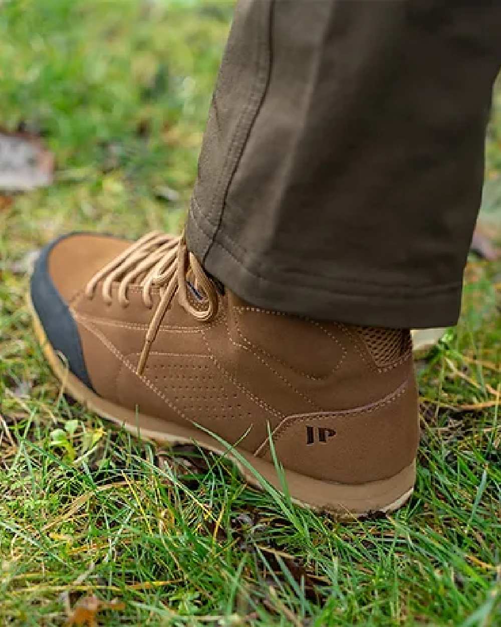 Brown coloured Jack Pyke Lowland Boots on grassy background #colour_brown