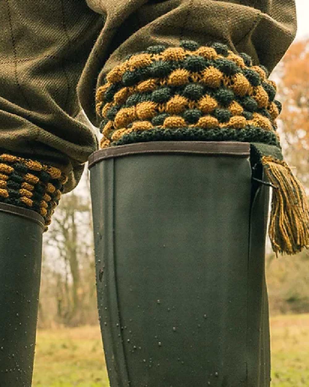 Green coloured Jack Pyke Pebble Socks on blurry background #colour_green
