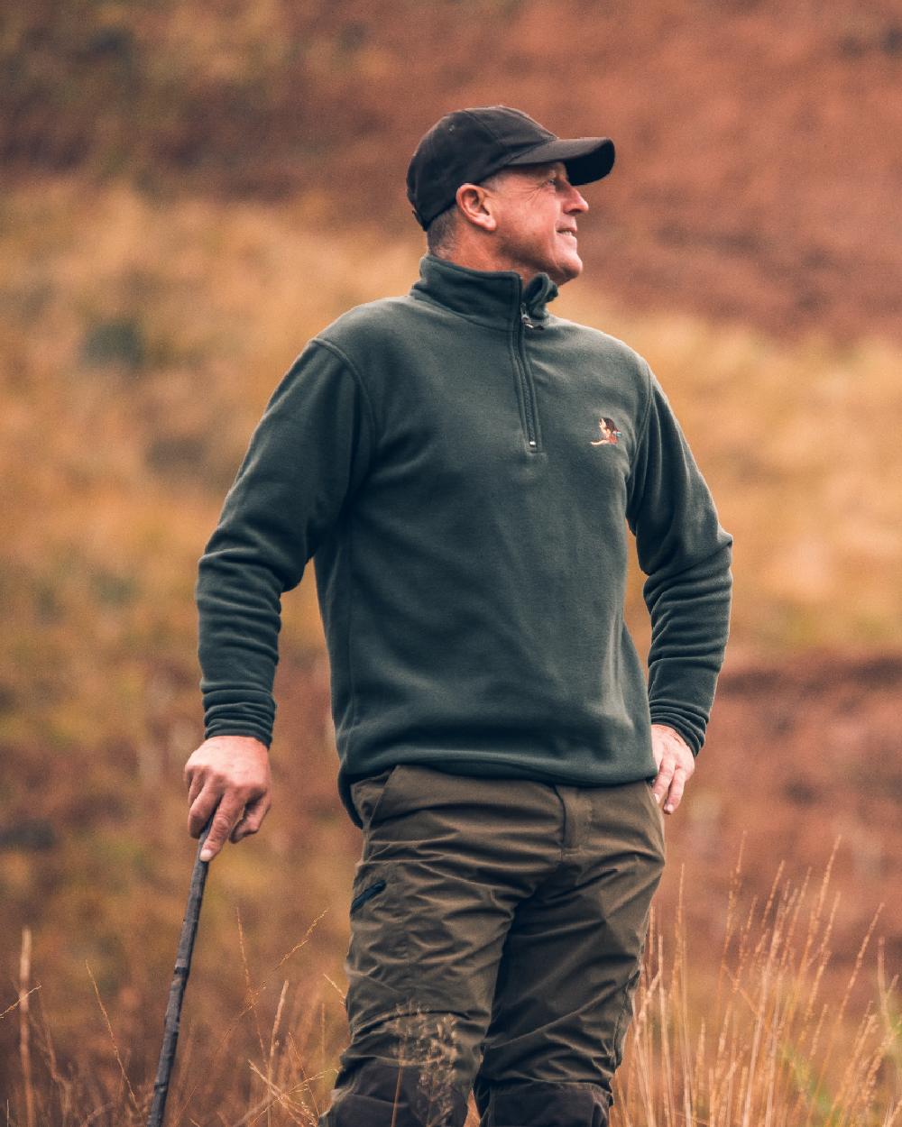 Green coloured Jack Pyke Pheasant Motif Fleece Pullover on blurry background #colour_green