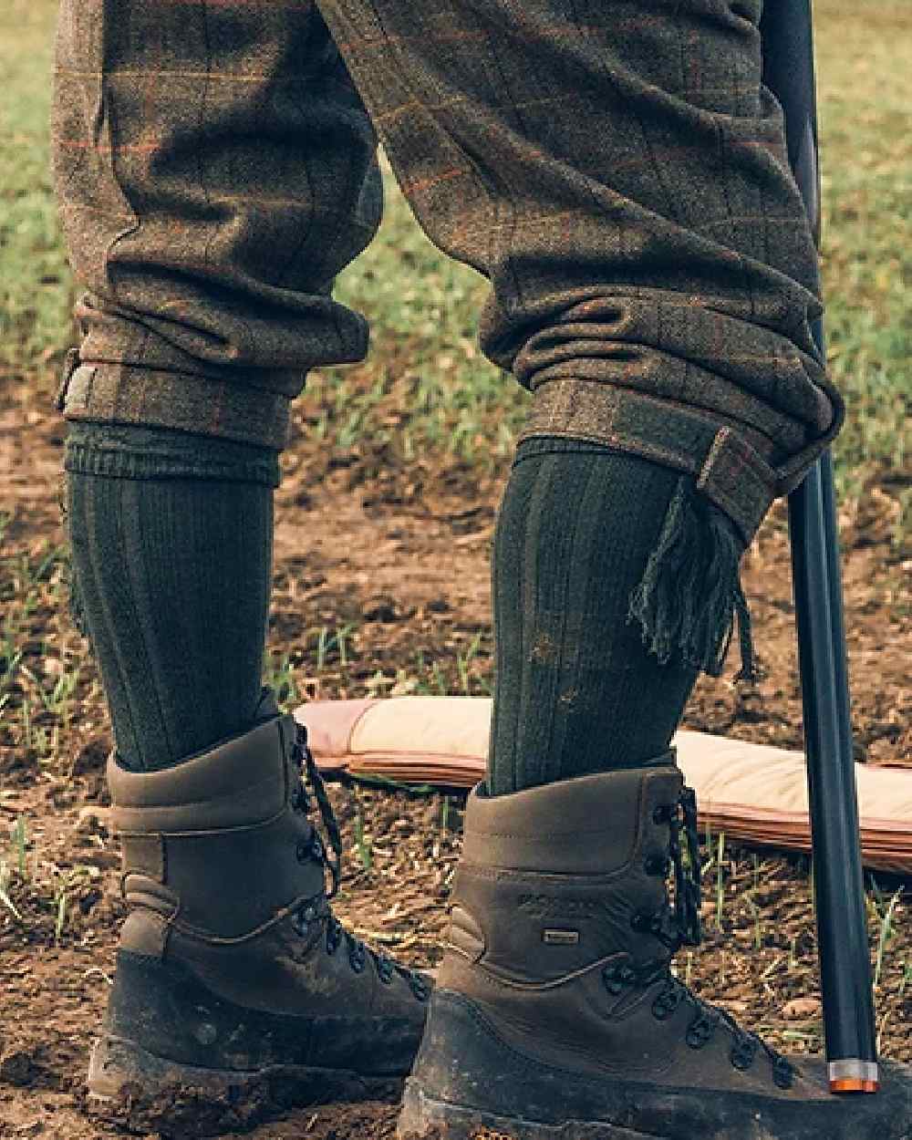 Green coloured Jack Pyke Plain Shooting Socks on mud background #colour_green