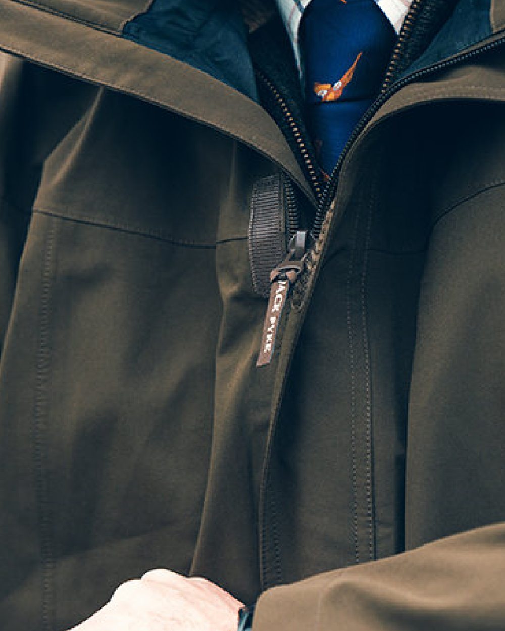 Green coloured Jack Pyke Pro-Lite Hunters Jacket on blurry background #colour_green