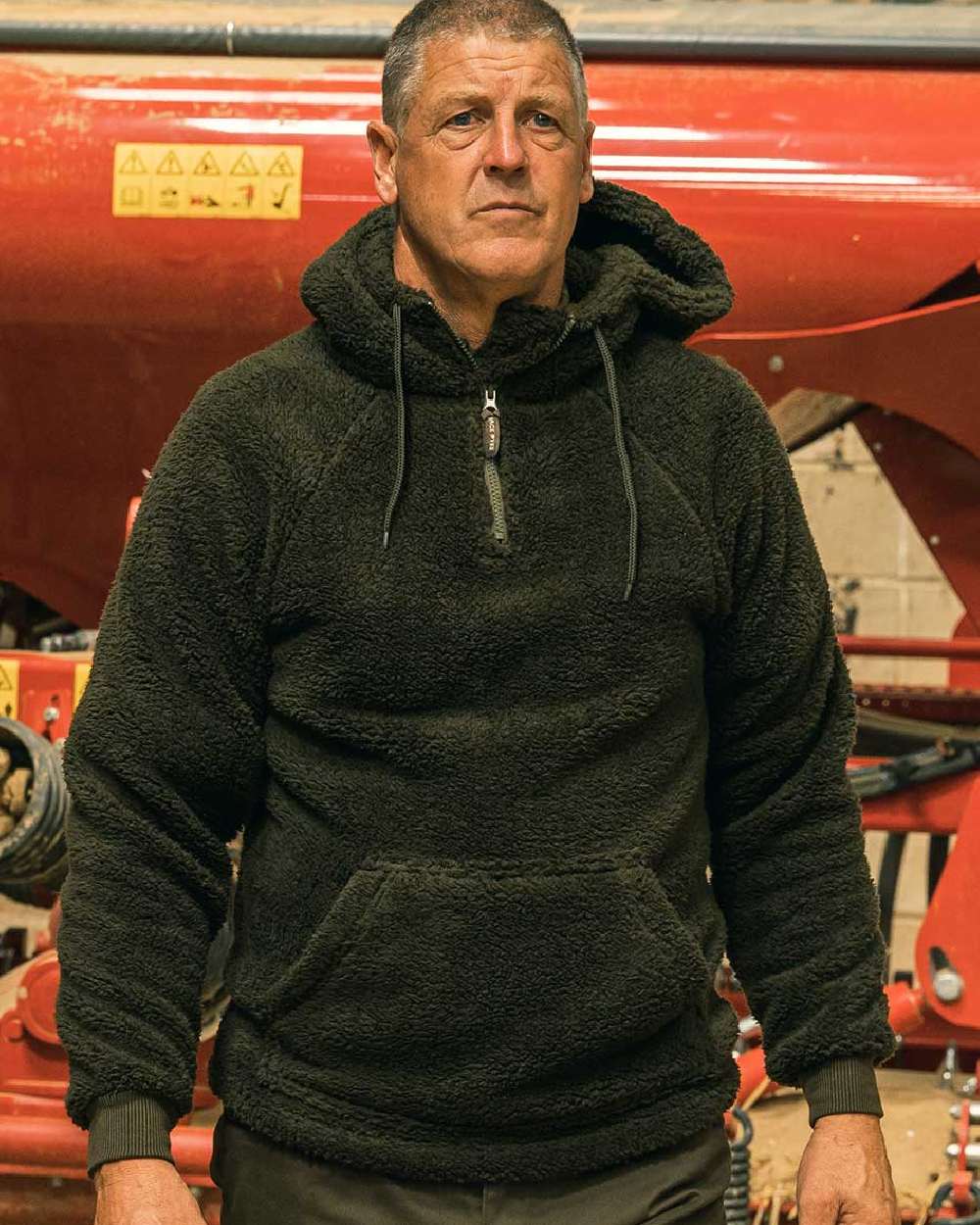 Dark Olive coloured Jack Pyke Sherpa Fleece Hoodie on machine background #colour_dark-olive