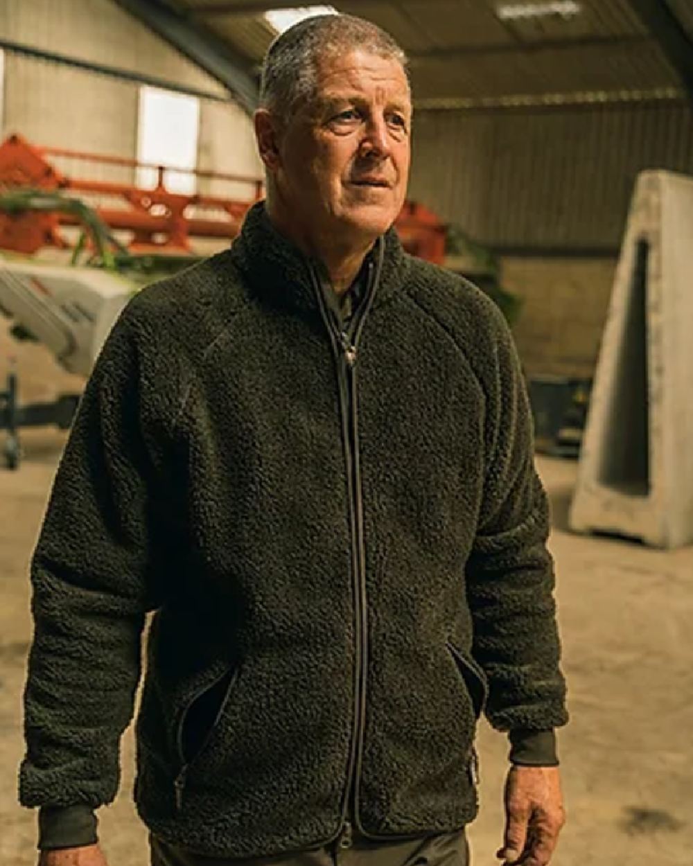 Dark Olive coloured Jack Pyke Sherpa Fleece Jacket on factory background #colour_dark-olive