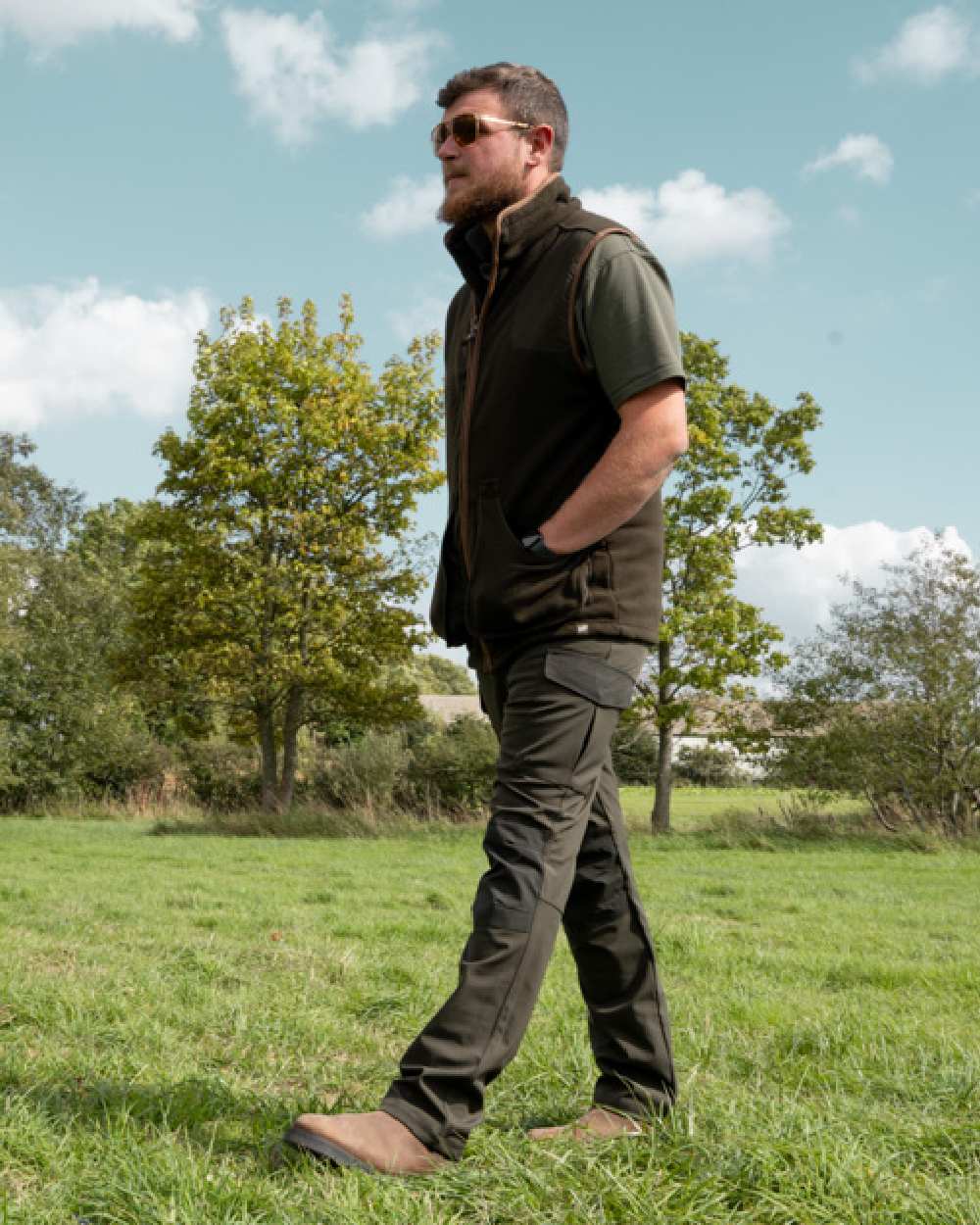Green coloured Jack Pyke Softshell Trousers on grass background #colour_green