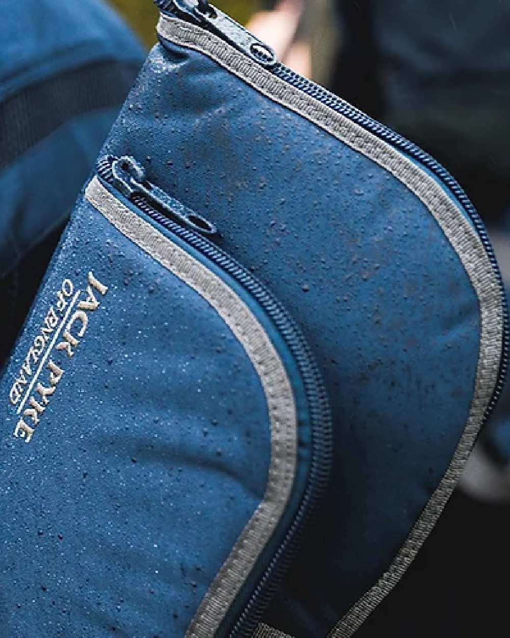Blue coloured Jack Pyke Sporting Gun Slip on blurry background #colour_blue