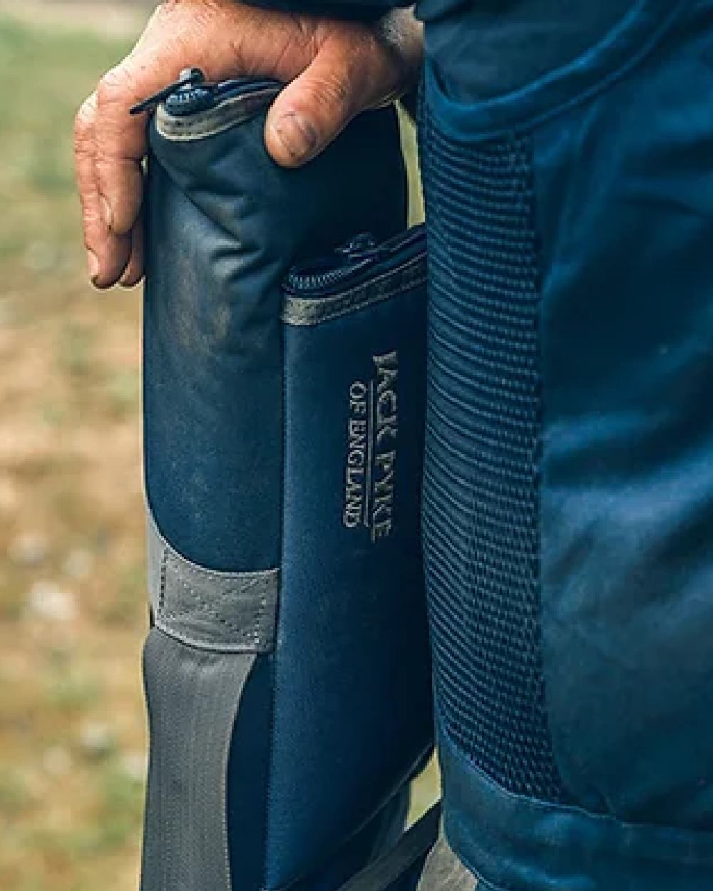 Blue coloured Jack Pyke Sporting Gun Slip on blurry background #colour_blue