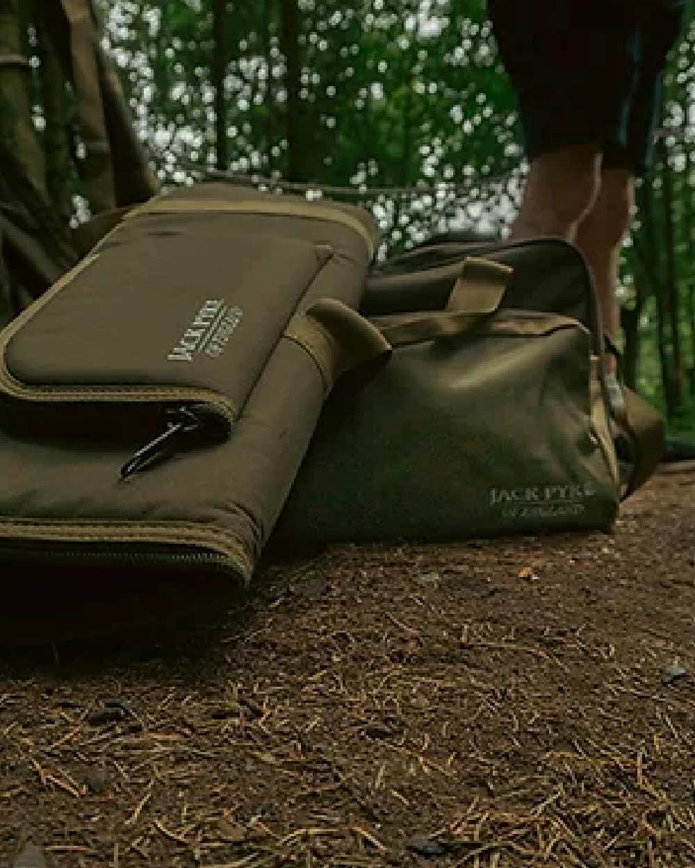Green coloured Jack Pyke Sporting Gun Slip on forest background #colour_green