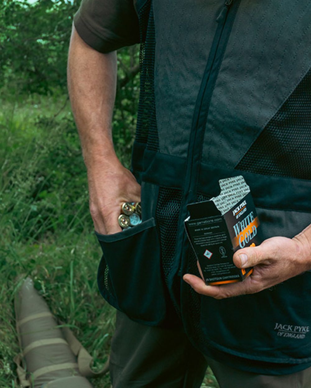 Black coloured Jack Pyke Sporting Skeet Vest on forest background #colour_black