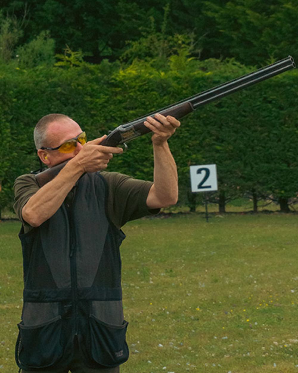 Black coloured Jack Pyke Sporting Skeet Vest on forest background #colour_black