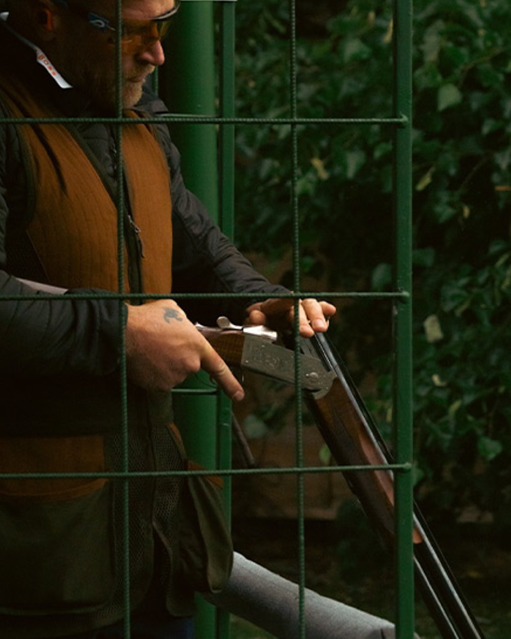 Green coloured Jack Pyke Sporting Skeet Vest on leafy background #colour_green