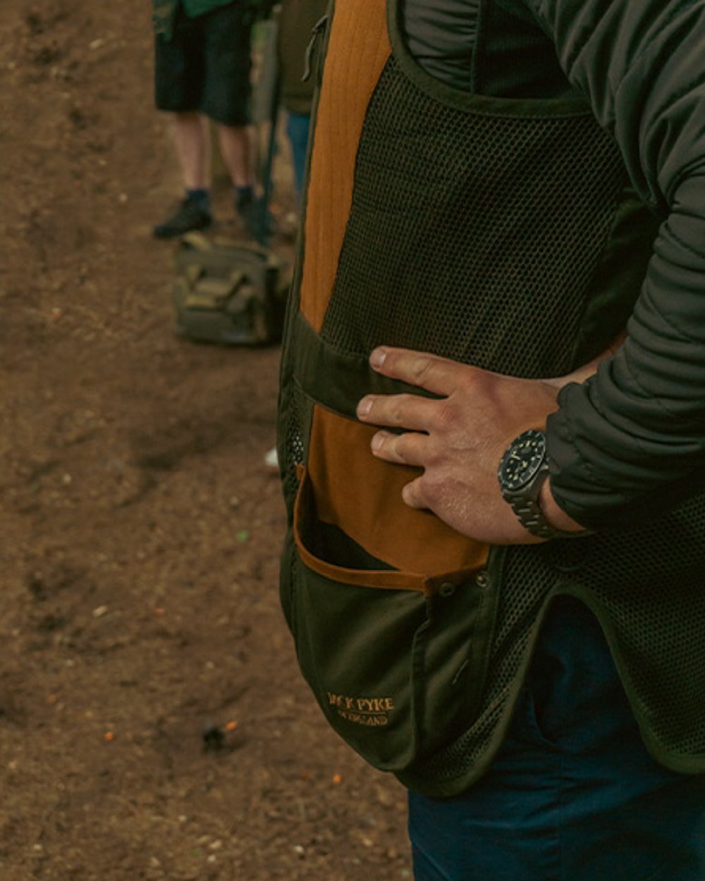 Green coloured Jack Pyke Sporting Skeet Vest on soil background #colour_green