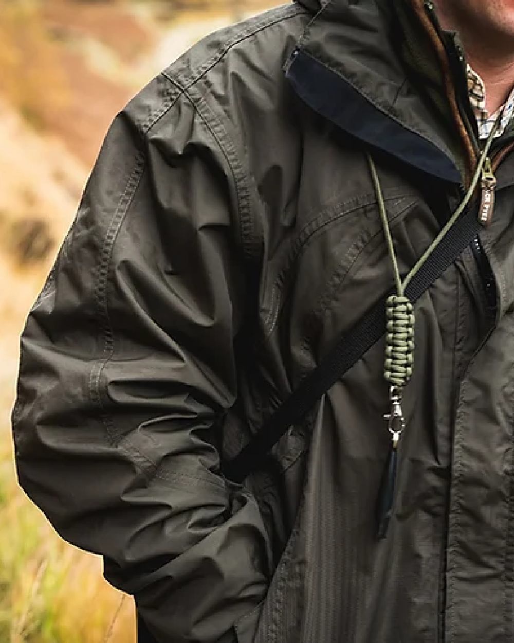 Hunter Green coloured Jack Pyke Technical Featherlite Jacket on mountain background #colour_hunter-green