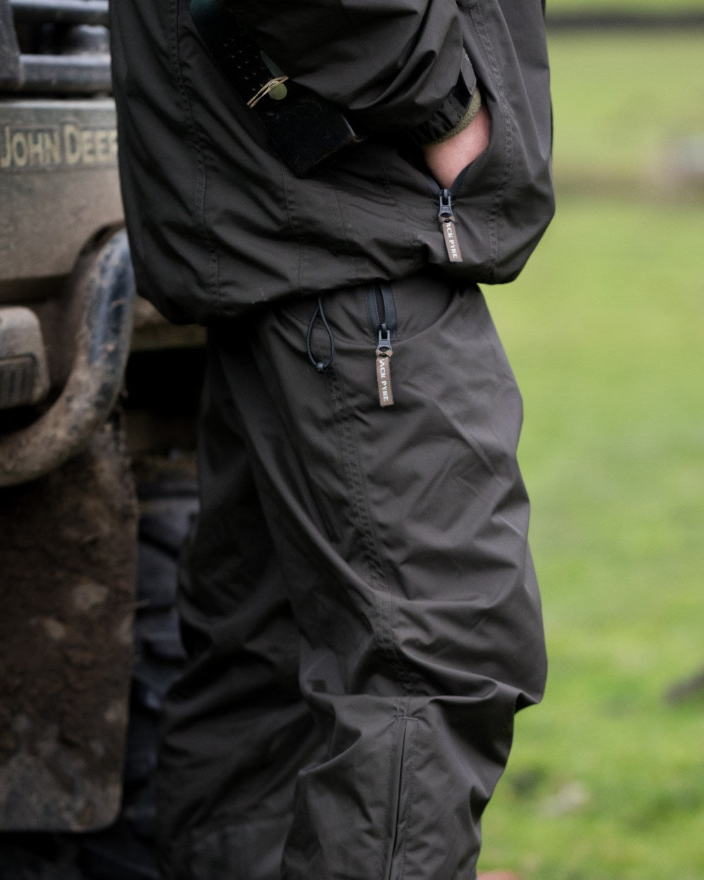 Hunters Green coloured Jack Pyke Technical Featherlite Trousers on grass background #colour_hunter-green