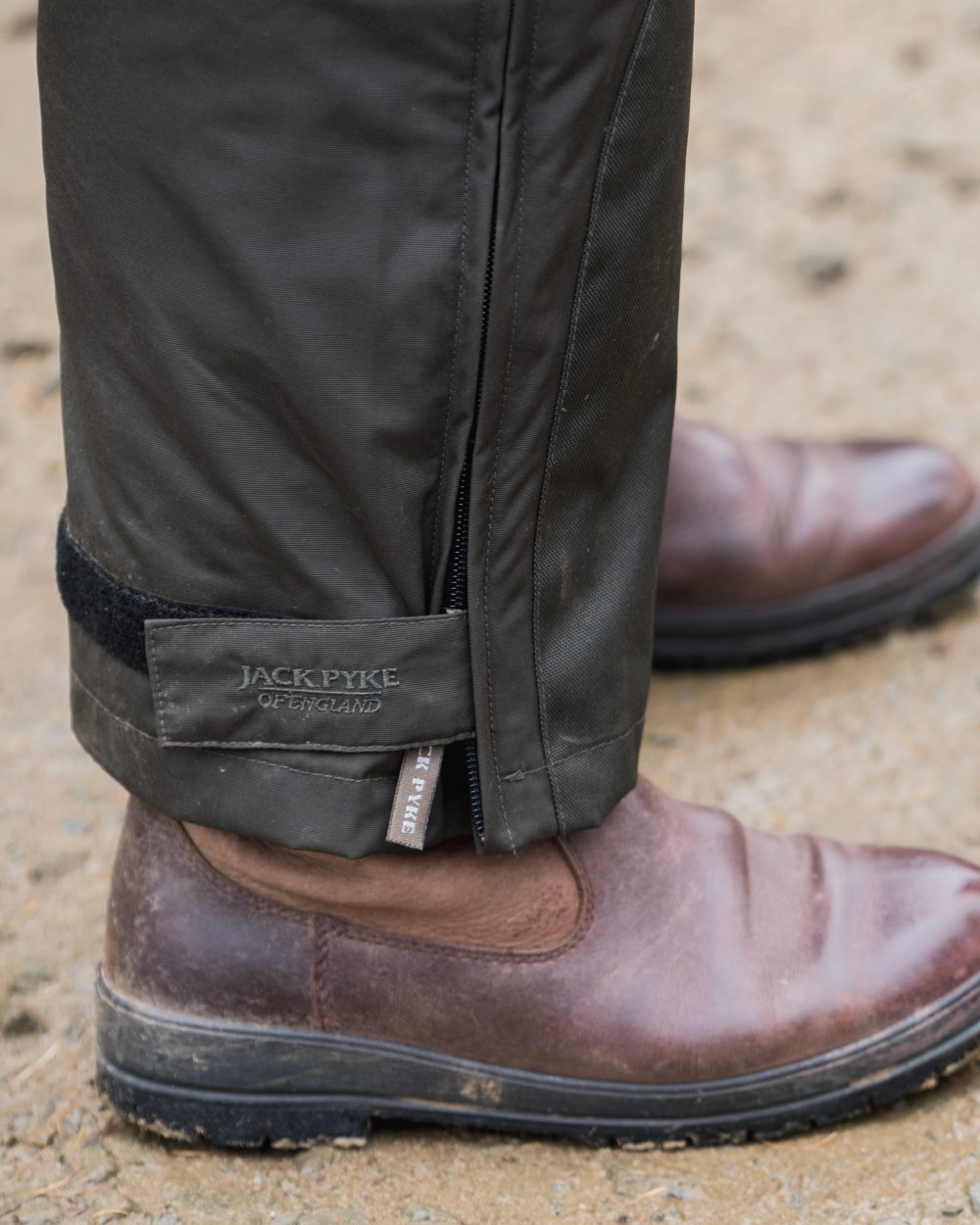Hunters Green coloured Jack Pyke Technical Featherlite Trousers on soil background #colour_hunter-green