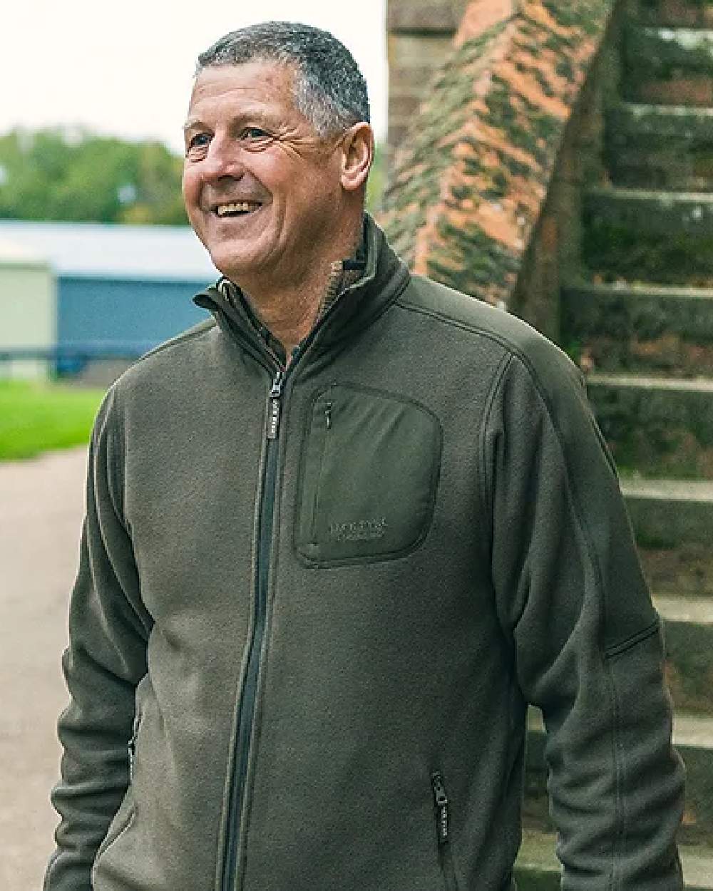Green coloured Jack Pyke Weardale Fleece Jacket on blurry background #colour_green