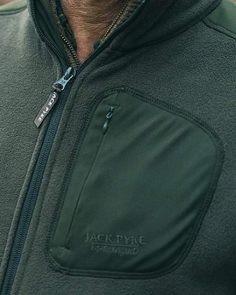 Green coloured Jack Pyke Weardale Fleece Jacket on blurry background #colour_green