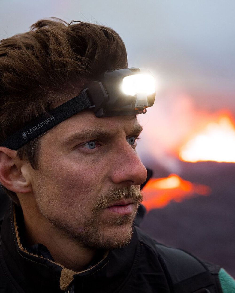 Black coloured Led Lenser HF8R Core Rechargeable Head Torch on blurry background #colour_black