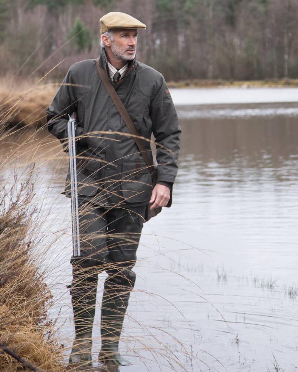 Khaki coloured Percussion Sologne Neoprene Wellington Boots on marshland background #colour_khaki