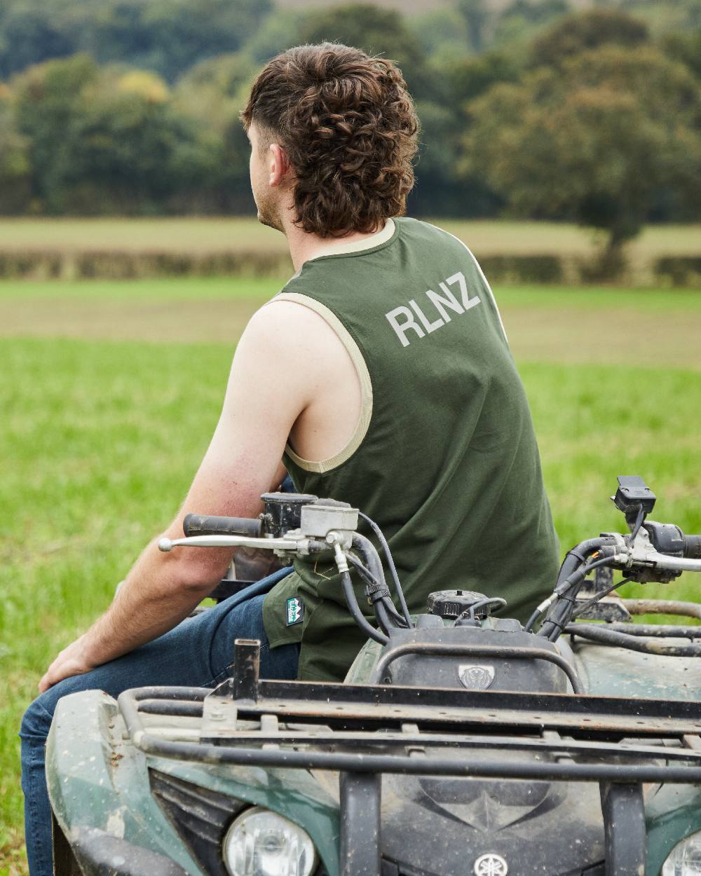 Olive Multi coloured Ridgeline Backslider Singlet Top on forest background #colour_olive-multi