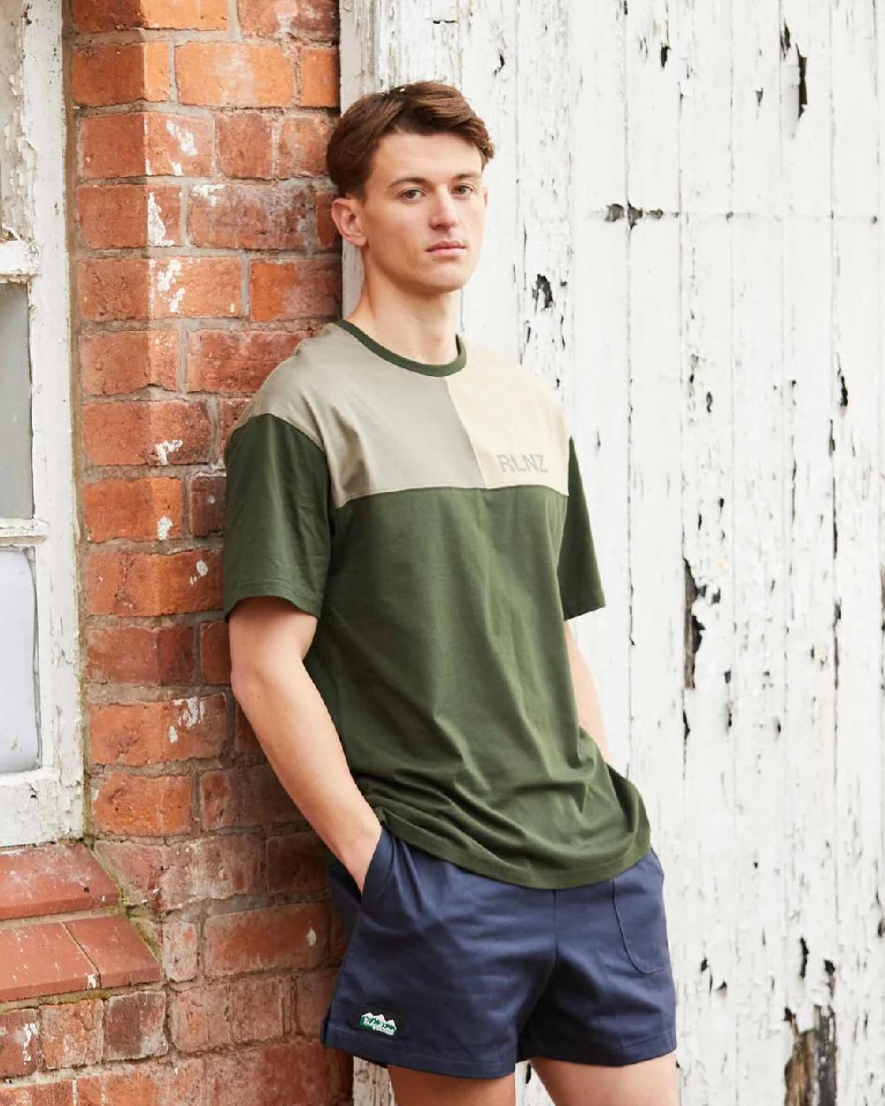 Navy coloured Ridgeline Hose Down Shorts on brick wall background #colour_navy