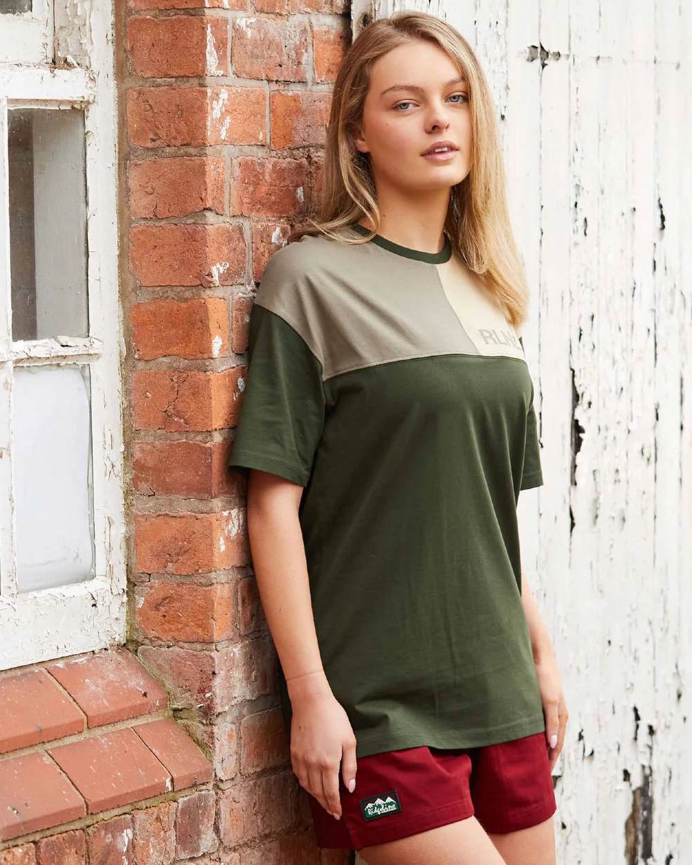 Rhubarb coloured Ridgeline Hose Down Shorts on brick wall background #colour_rhubarb