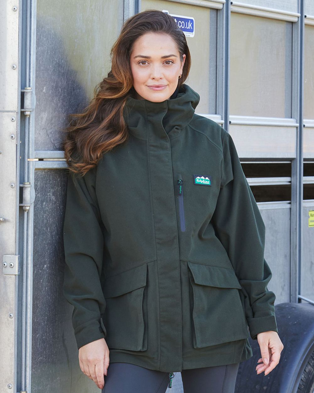 Deep Forest coloured Ridgeline Ladies Rhea Jacket on outdoor background #colour_deep-forest