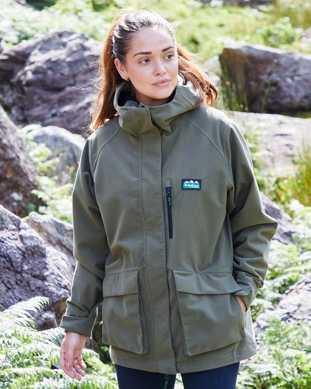 Ivy Green coloured Ridgeline Ladies Rhea Jacket on rock background #colour_ivy-green