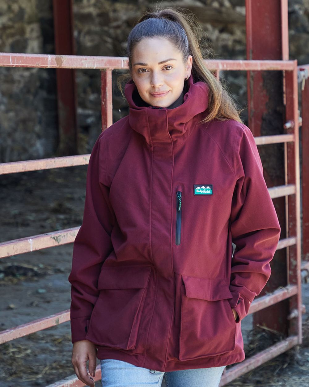 Winter Berry coloured Ridgeline Ladies Rhea Jacket on rock background #colour_winter-berry