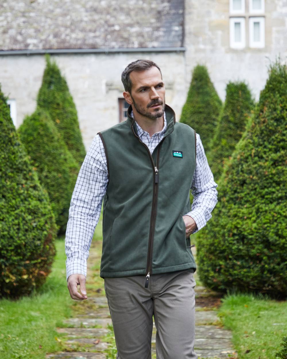 Deep Forest coloured Ridgeline Mens Monarch Gilet on lawn background #colour_deep-forest