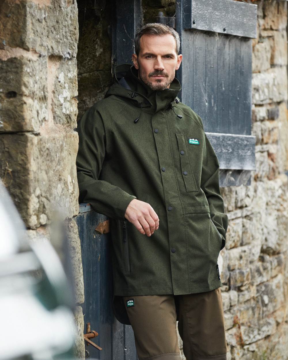 Deep Forest Marl coloured Ridgeline Mens Monsoon Light Jacket on wall background #colour_deep-forest-marl