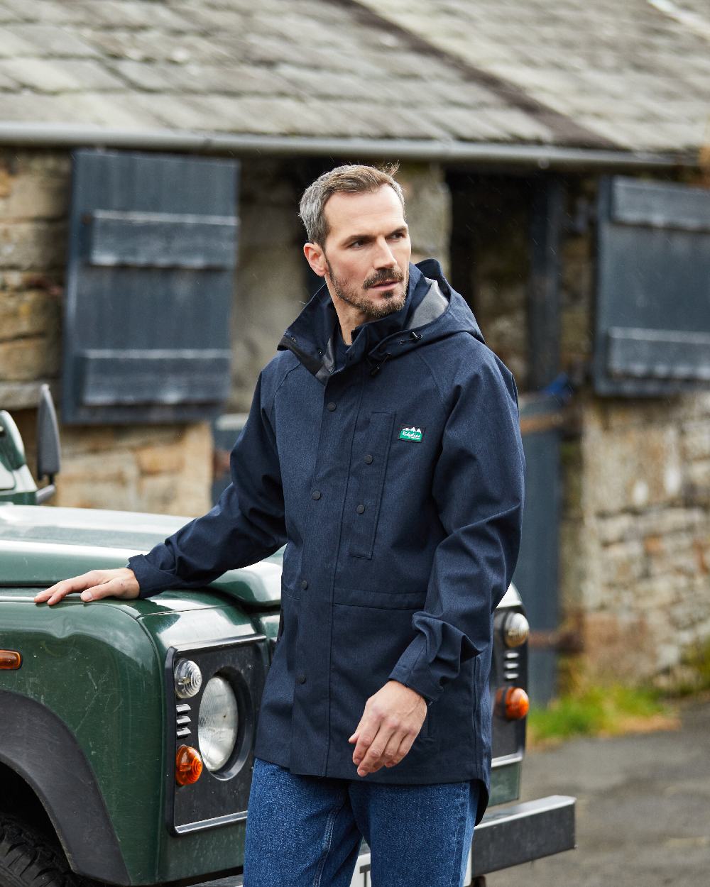 Navy Marl coloured Ridgeline Mens Monsoon Light Jacket on house background #colour_navy-marl