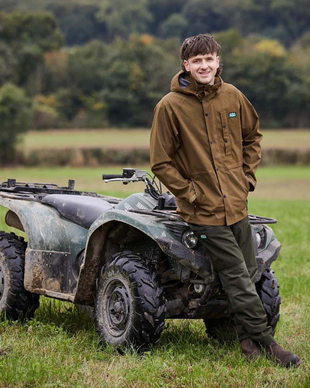 Teak coloured Ridgeline Mens Monsoon Light Jacket on farm background #colour_teak
