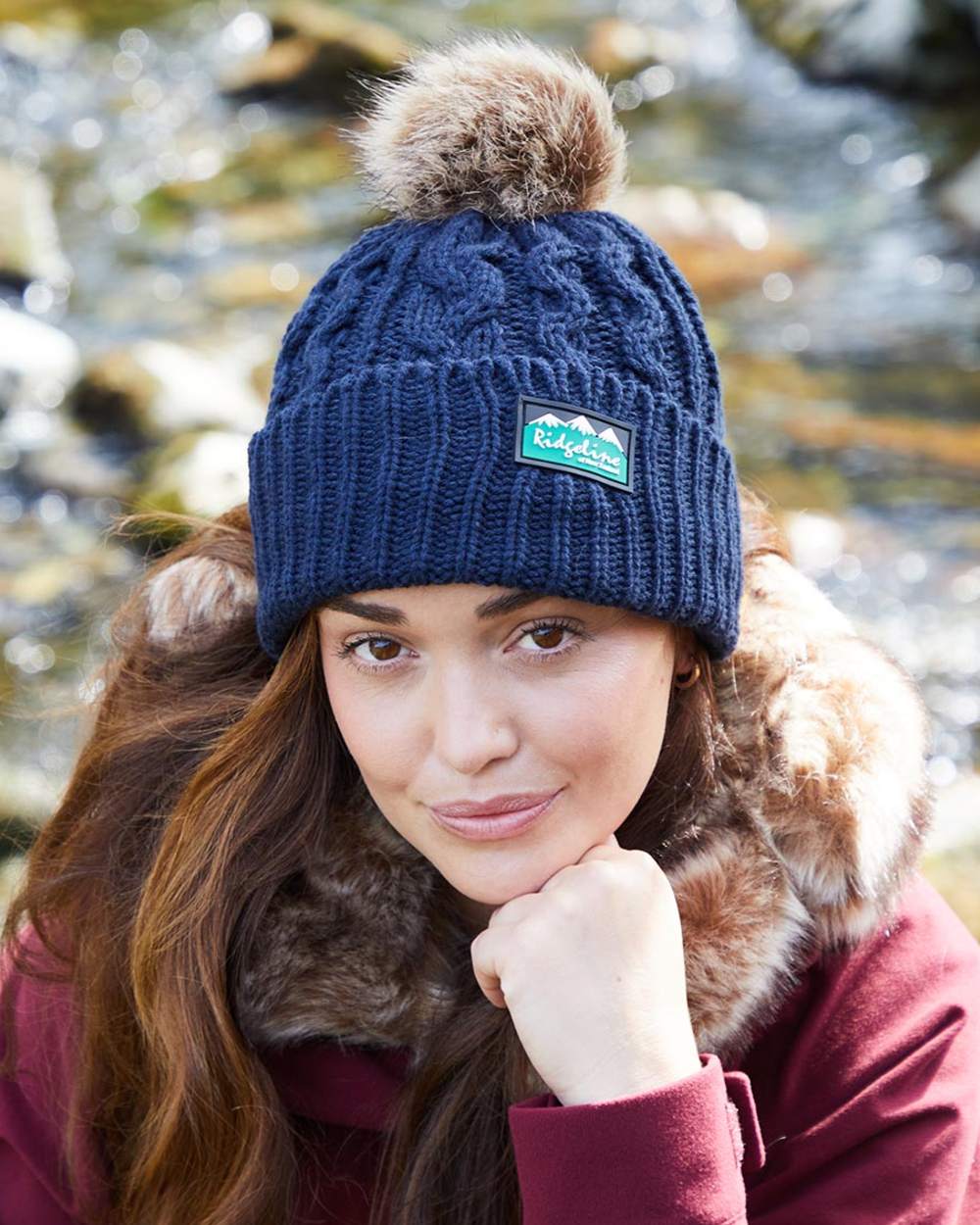 Navy coloured Ridgeline Nordic Fleck Bobble Hat on water background #colour_navy