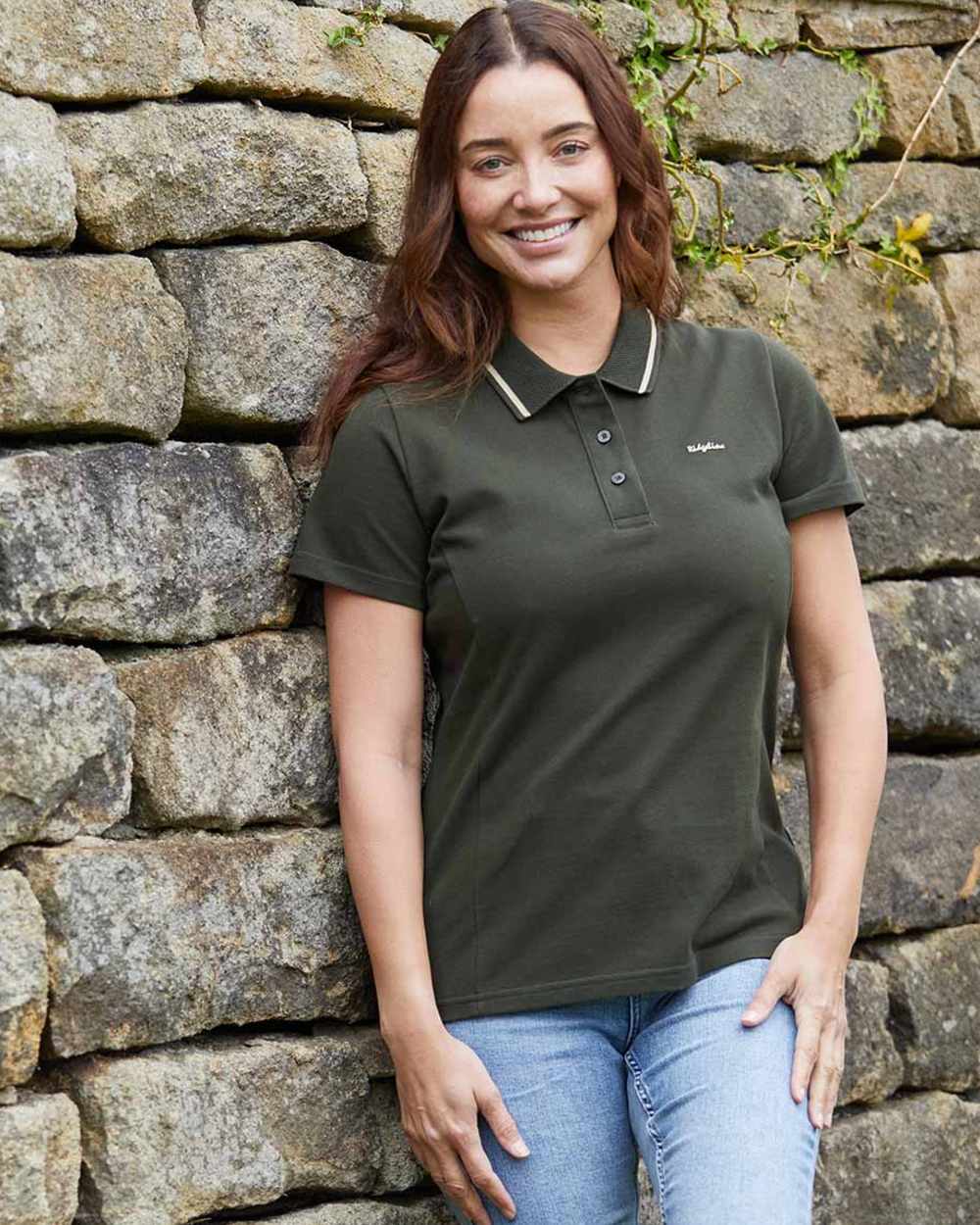 Smokey Olive coloured Ridgeline Womens Kilworth Polo Shirt on stone wall background #colour_smokey-olive