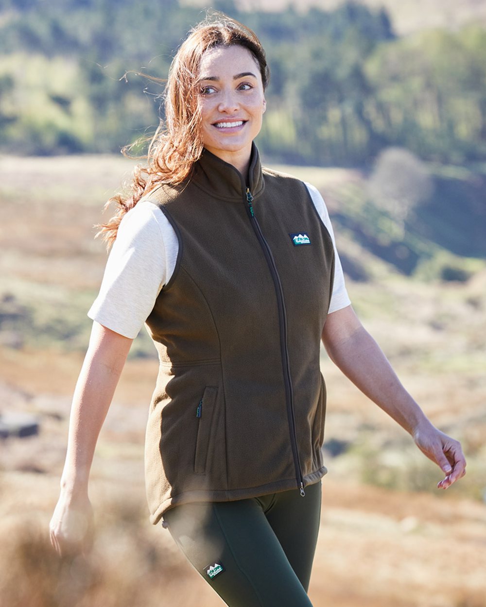 Moody Teak coloured Ridgeline Womens Kodiak Gilet on mountain background #colour_moody-teak