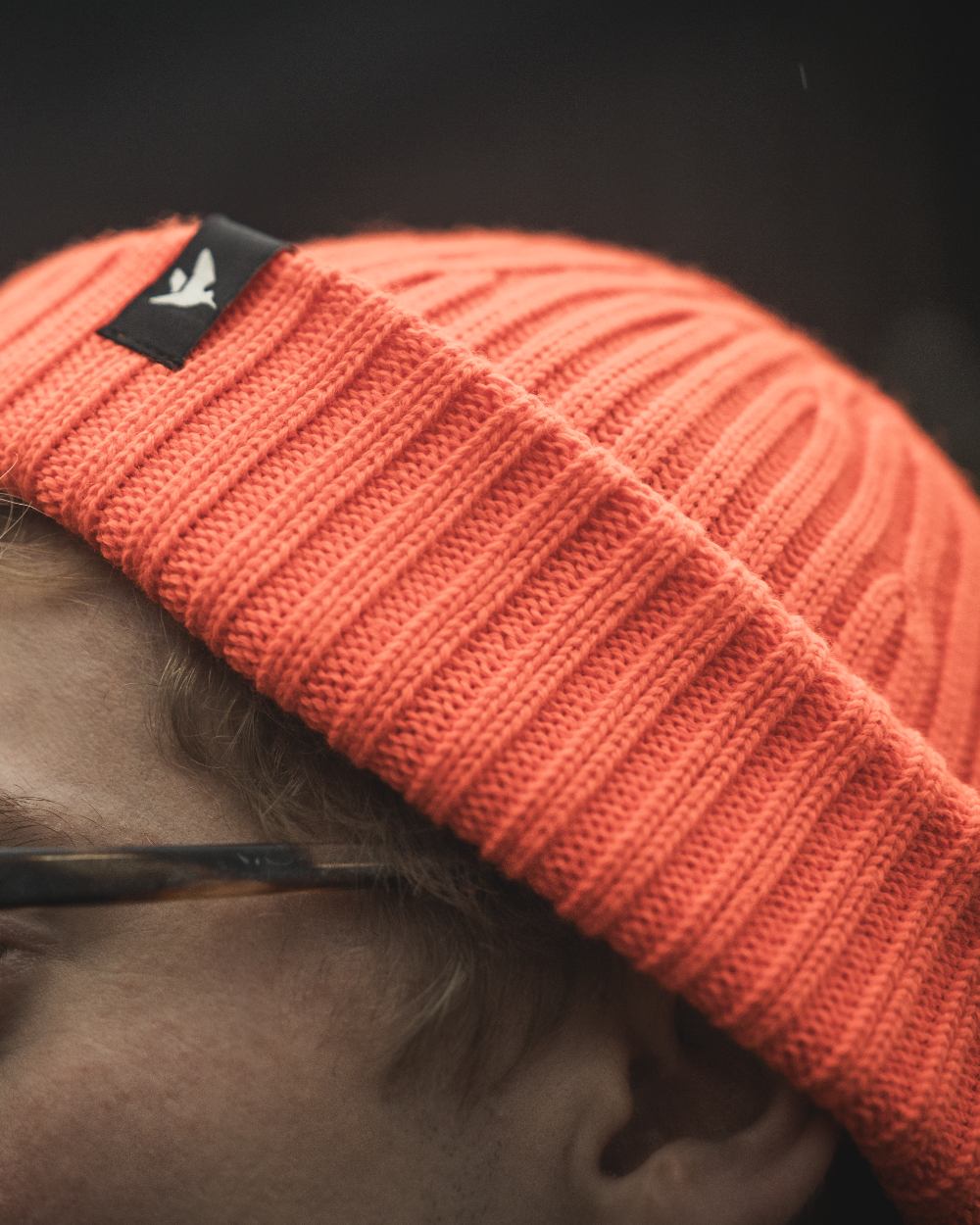 Orange Blaze Coloured Seeland Norite Beanie On A forest Background #colour_orange-blaze