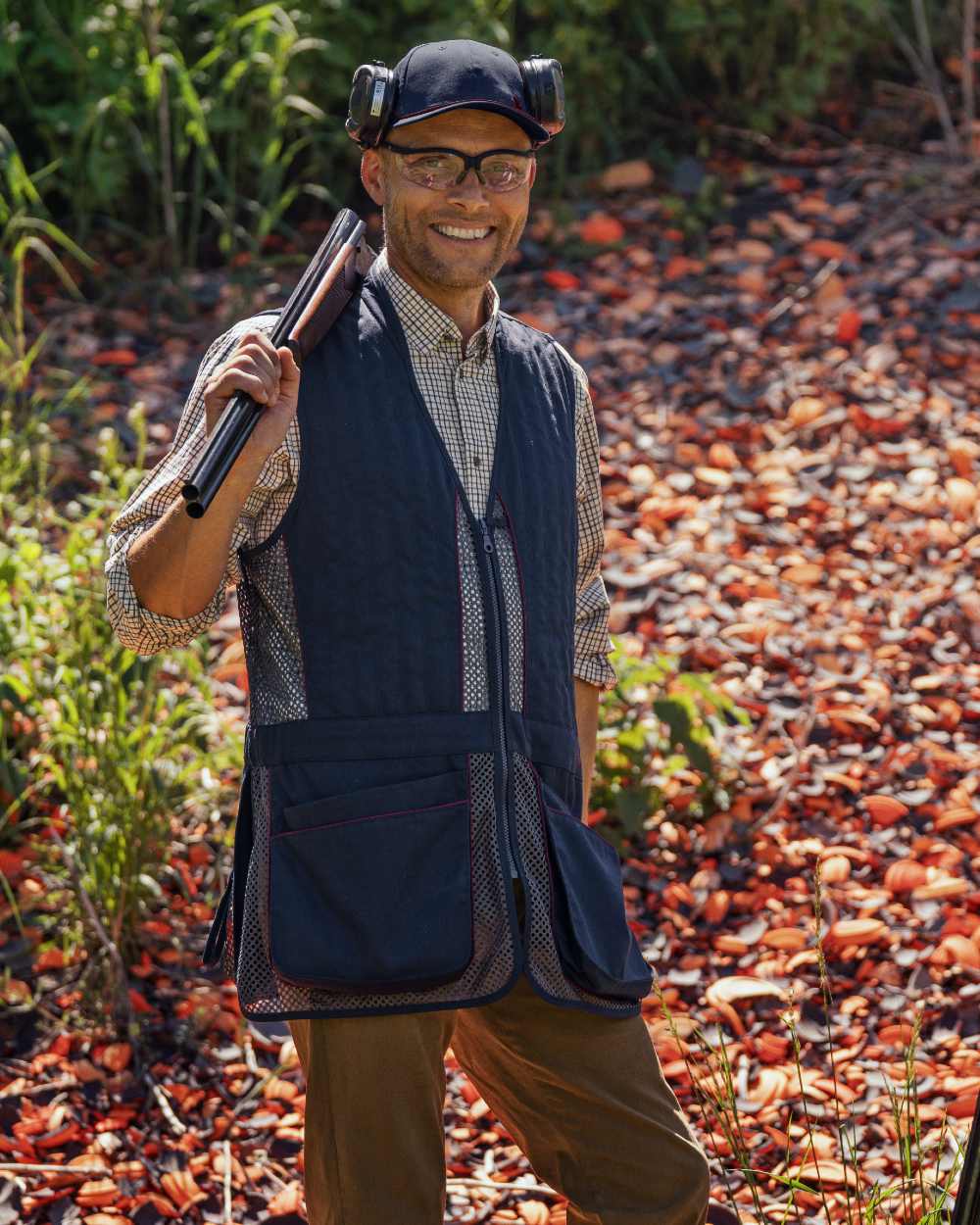 Classic Blue coloured Seeland Skeet II Waistcoat on forest background #colour_classic-blue