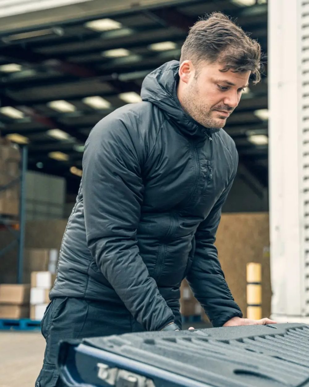 Black Coloured Viper Frontier Jacket on warehouse background #colour_black