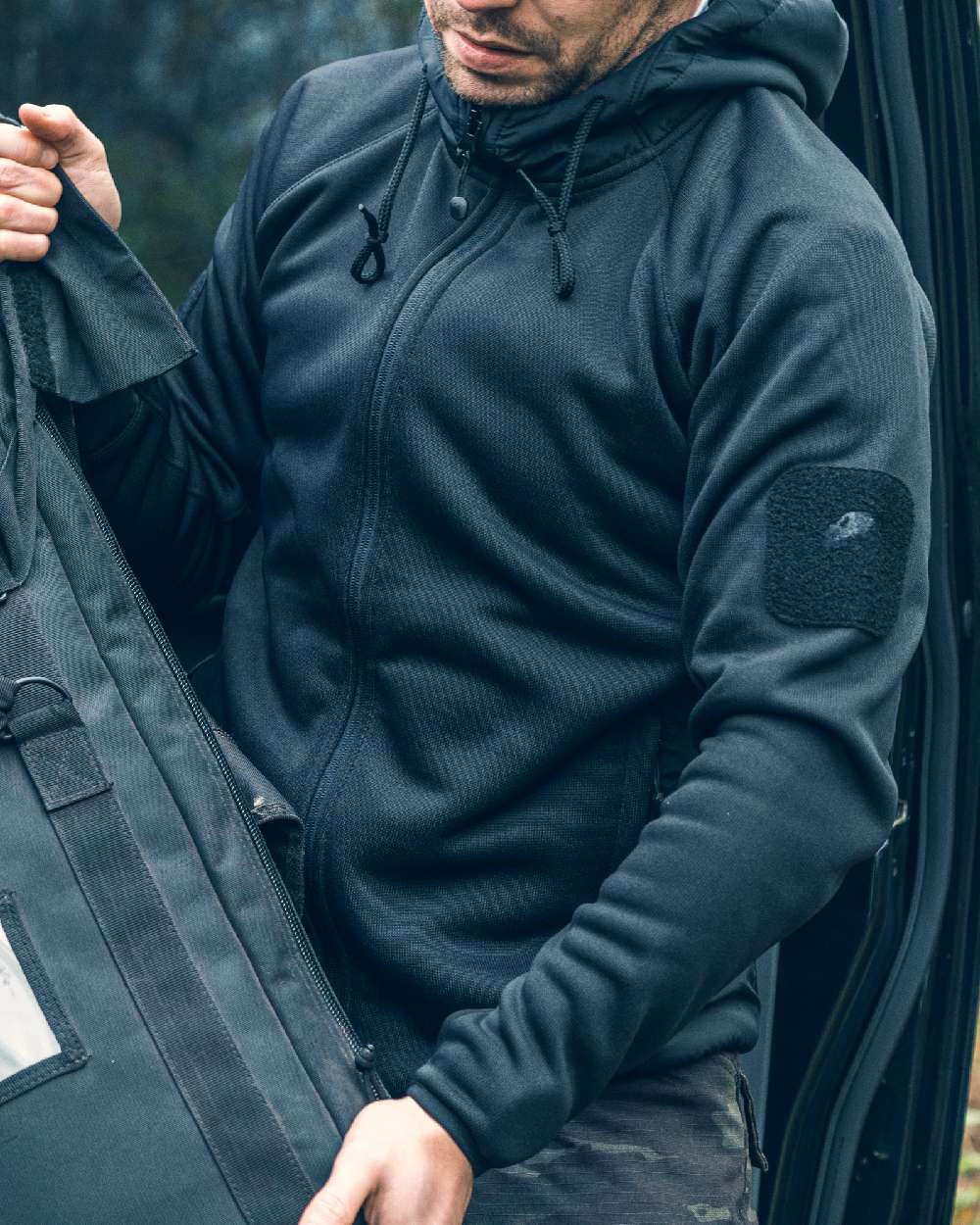 Black coloured Viper Storm Hoodie on blurry background #colour_black