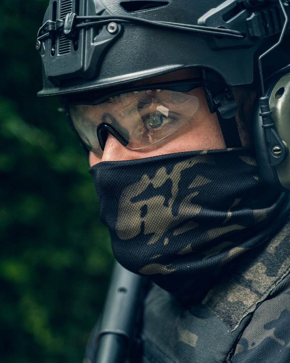 VCAM Black Coloured Viper Tactical Roll Neck Top on blurry background #colour_vcam-black