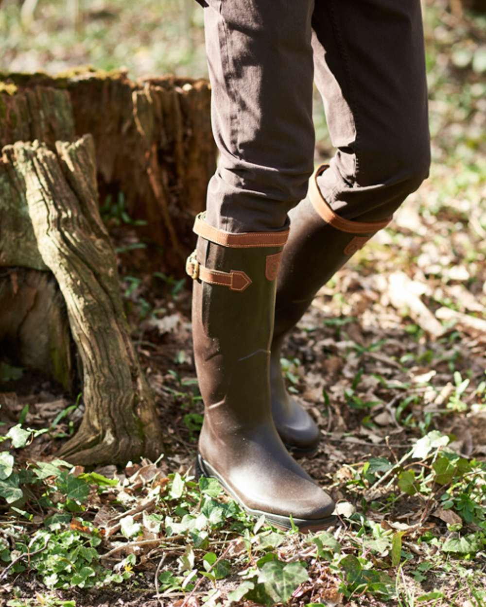Dark Brown Coloured Aigle Parcours 2 Signature Wellingtons On A Forest Background #colour_dark-brown