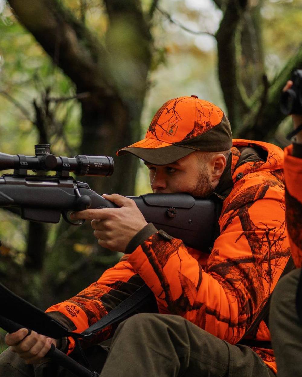 Realtree Edge Orange Coloured Deerhunter Eagle Cap On A Forest Background #colour_realtree-edge-orange