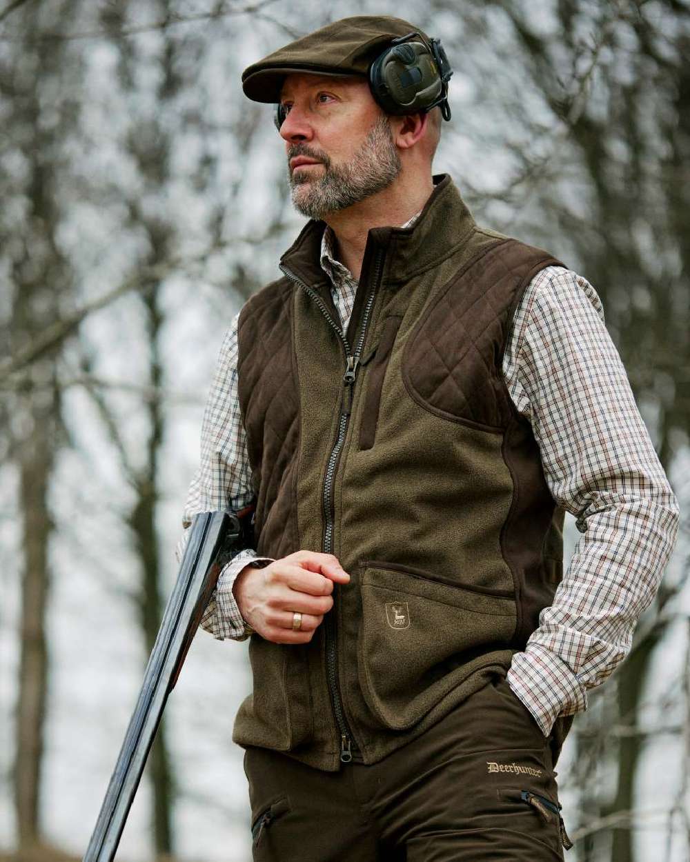 Tarmac Green coloured Deerhunter Eagle Flat Cap on forest background #colour_tarmac-green